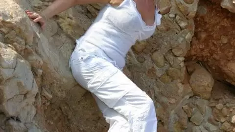 Hot blonde with big tits Electra removing clothes in the rocks 