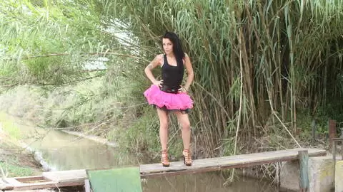 Pornstar little brunette Jordanne Kali getting naked by the river 
