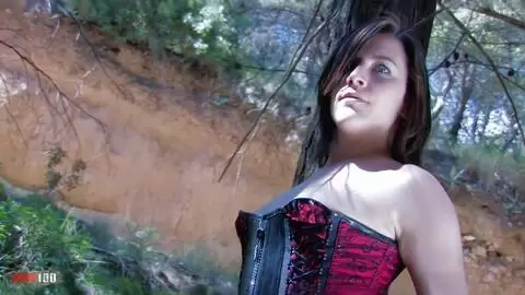 Sexy brunette striping in the woods