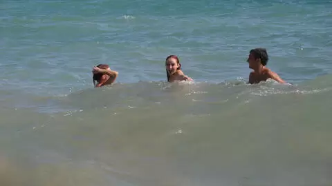 Pornstar little redhead Lola Bella removing clothes by the sea 