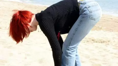 Pretty redhead Mahylis stripping on the beach 