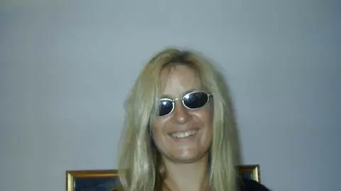 Hot mature blonde with big tits Martha removing clothes on the bed 