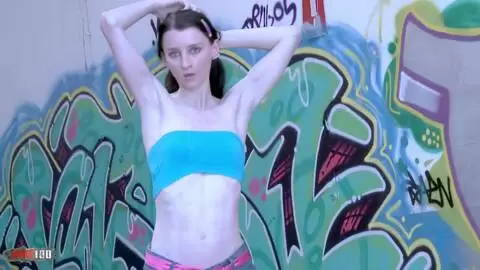 The young French Pauline Cooper does a striptease in front of a Tag wall